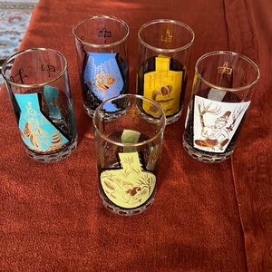 Vintage highball drinking glasses with mid-century Egyptian inspired designs.